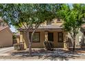 Charming two-story home featuring a covered porch and manicured front yard with desert landscaping at 3552 E Carla Vista Dr, Gilbert, AZ 85295