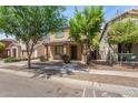 Delightful home with covered porch and desert landscaping creating an inviting curb appeal at 3552 E Carla Vista Dr, Gilbert, AZ 85295