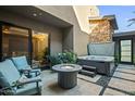 Outdoor patio featuring a hot tub, seating around a fire pit, and sleek tiled flooring at 37200 N Cave Creek Rd # 1122, Scottsdale, AZ 85262