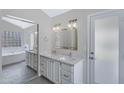 Bright bathroom with double vanity, large mirrors, and walk-in tub at 4031 N Ranier --, Mesa, AZ 85215