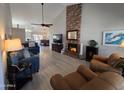 Spacious living room featuring a brick fireplace, vaulted ceilings, and contemporary furnishings at 4525 E Desert View Dr, Phoenix, AZ 85044
