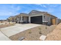 Stylish single-story house featuring a spacious driveway and garage, complemented by desert landscaping at 46378 W Lander Ln, Maricopa, AZ 85139