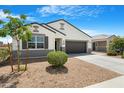 Inviting single-story home with tidy landscaping and a convenient two-car garage at 5237 W Alta Mesa Ave, Laveen, AZ 85339