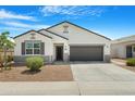 Well-maintained single-story home with gray accents and a two-car garage at 5237 W Alta Mesa Ave, Laveen, AZ 85339