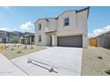 Attractive two-story home boasts a large driveway and a well-maintained xeriscaped front yard at 5535 S 240Th Ln, Buckeye, AZ 85326