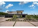 Contemporary home with stylish landscaping, driveway, and a multi-car garage at 5814 E Camelback Rd, Phoenix, AZ 85018