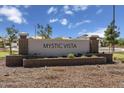 Welcome to Mystic Vista, a beautiful community with lush landscaping and a welcoming entrance at 5870 S 246Th Ln, Buckeye, AZ 85326