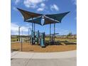 Community playground with slides, climbing structures, and a shaded area for children to play at 5870 S 246Th Ln, Buckeye, AZ 85326