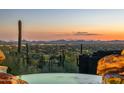 Tranquil pool overlooking a stunning desert landscape at sunset at 6001 E Restin Rd, Cave Creek, AZ 85331