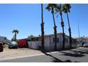 Charming mobile home with tall palm trees and a bright red bougainvillea bush at 625 W Mckellips Rd # 279, Mesa, AZ 85201
