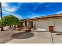 Inviting exterior view of a home showcasing a two-car garage and a quaint front patio at 8160 E Keats Ave # 339, Mesa, AZ 85209