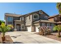 Charming two-story home with a three-car garage, desert landscaping, and a neutral color palette at 1051 E Julie Ave, San Tan Valley, AZ 85140