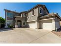 Attractive two-story home showcasing a three-car garage and inviting curb appeal with desert landscaping at 1051 E Julie Ave, San Tan Valley, AZ 85140