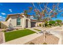 Charming single-story home with well-manicured lawn, beautiful brick driveway, and neutral stucco exterior at 14640 W Dahlia Dr, Surprise, AZ 85379