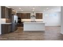 Kitchen area featuring an island with a sink, stainless steel appliances, hardwood flooring, and recessed lighting at 14739 W El Cortez Pl, Surprise, AZ 85387