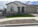 Attractive single-story house boasting a tile roof, artificial grass, and decorative rock landscaping at 15911 W Montana De Oro Dr, Surprise, AZ 85387