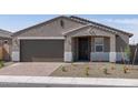 Inviting single-Gathering home featuring a neat front yard and a two-car garage, offering comfort and convenience at 17809 W Elm St, Goodyear, AZ 85395