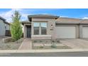 Beautiful home with neutral tones, manicured landscape, and a spacious two-car garage at 18332 E Spring Valley Ct, Rio Verde, AZ 85263