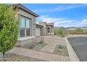Charming home with desert landscaping and a brick paver driveway at 18332 E Spring Valley Ct, Rio Verde, AZ 85263