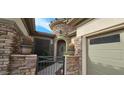 Close up of front door with gated entry and decorative cactus planters at 19245 W Pasadena Ave, Litchfield Park, AZ 85340