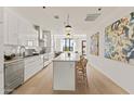 Modern kitchen with stainless steel appliances, island with seating and an open design leading to the living area at 312 E Windsor Ave # 3, Phoenix, AZ 85004
