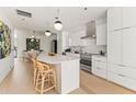 Bright kitchen features stainless steel appliances, island seating and contemporary lighting fixtures at 312 E Windsor Ave # 3, Phoenix, AZ 85004
