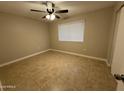 Bedroom with tile flooring, neutral colors, fan, and a bright window at 3314 W Del Monico Ln, Phoenix, AZ 85051