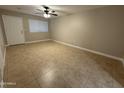 A cozy living room featuring tile flooring, neutral colors, and ample natural light at 3314 W Del Monico Ln, Phoenix, AZ 85051