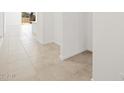 Bright hallway featuring tile floors and freshly painted white walls at 3582 E Audrey Dr, San Tan Valley, AZ 85143