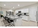 Bright kitchen features gray granite countertops, white cabinetry and stainless steel appliances at 46395 W Lander Ln, Maricopa, AZ 85139