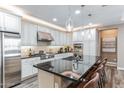 Modern kitchen featuring stainless steel appliances, white cabinets, a granite countertop, and a breakfast bar at 4777 S Fulton Ranch Blvd # 1032, Chandler, AZ 85248