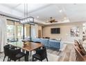 Open-concept space with wood floors, a dining table, and a comfortable seating area with a large sectional sofa at 4777 S Fulton Ranch Blvd # 1032, Chandler, AZ 85248