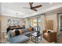 Comfortable living room with a large sectional sofa, coffee table, and sliding glass doors to the backyard at 4777 S Fulton Ranch Blvd # 1032, Chandler, AZ 85248