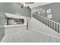 Modern living room open to kitchen, with a high ceiling, and staircase with gallery wall, perfect for entertaining at 633 W Southern Ave # 1131, Tempe, AZ 85282