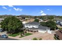 Expansive home with a well-manicured lawn and mature trees, offering privacy and curb appeal at 645 S 54Th St, Mesa, AZ 85206