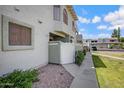 Townhouse exterior with a white fence, desert landscaping, and a sunny sky at 850 S River Dr # 1068, Tempe, AZ 85281