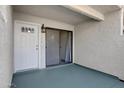 Covered patio featuring a white front door and sliding glass doors at 850 S River Dr # 1068, Tempe, AZ 85281