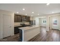 Modern kitchen featuring an island, granite countertops, stainless steel appliances and wood floors at 1102 W West Virginia Ave, Florence, AZ 85132