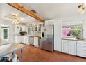 Bright kitchen featuring stainless steel appliances, white cabinets, and wood countertops at 12501 E Cloud Rd, Chandler, AZ 85249