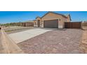 New construction home with concrete driveway, desert landscaping and turf accents for a low-maintenance yard at 14861 S Capistrano Rd, Arizona City, AZ 85123
