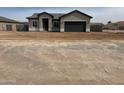 Single-story home with neutral-colored stucco, an attached two-car garage, and desert landscaping at 14861 S Capistrano Rd, Arizona City, AZ 85123