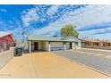 A single-story home featuring a carport and drought-resistant landscaping at 1510 W 7Th Dr, Mesa, AZ 85202