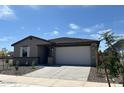 Charming single-story home featuring neutral paint, desert landscaping, and an attached two-car garage at 16071 W Remuda Dr, Surprise, AZ 85387