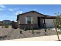 Charming single-story home featuring neutral paint, desert landscaping, and an attached two-car garage at 16071 W Remuda Dr, Surprise, AZ 85387