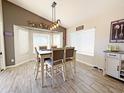 Dining room area with modern lighting, table and chairs, and large windows at 16325 W Paradise Ln, Surprise, AZ 85388