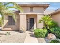 The front door of this home is inviting and features desert landscaping with a welcome sign at 16384 W Salado Creek Dr, Surprise, AZ 85387