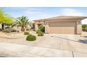 Attractive single-story home featuring a low maintenance desert landscape and a two car garage at 16384 W Salado Creek Dr, Surprise, AZ 85387