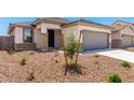 A well maintained single story home with a two car garage and desert landscaping at 17043 W Fetlock Trl, Surprise, AZ 85387