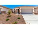Charming single-story home features a two-car garage and desert landscaping at 17043 W Fetlock Trl, Surprise, AZ 85387