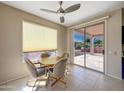 Cozy breakfast nook with tile flooring, ceiling fan, and sliding door access to the patio at 19982 N Tealstone Dr, Surprise, AZ 85374